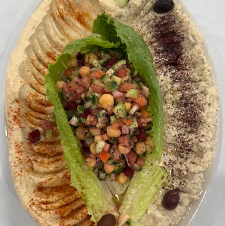 Hummus and baba ghanoush plated with Arabic salad